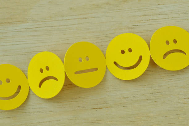 istock Chain of yellow smiley faces with positive, neutral and negative expression 1352270713