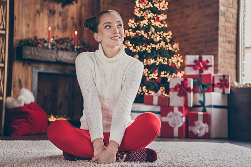 Full length photo of young girl happy positive smile sit floor dream think present box eve time holiday atmosphere  indoors