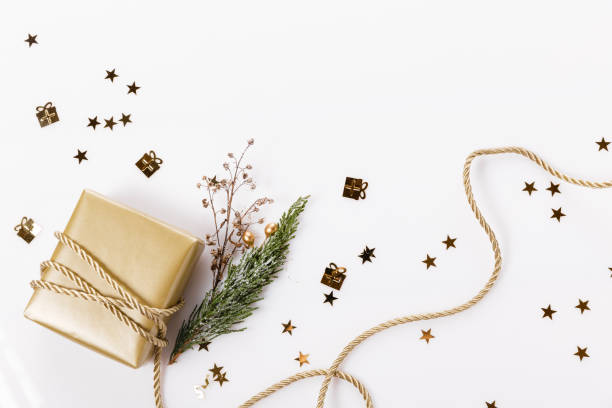 istock Christmas composition. Golden christmas gift, thuja branches and ribbon. Flat lay, top view 1352272416