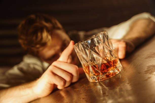istock Man drinking whiskey. Alcohol addiction concept. 1352273318