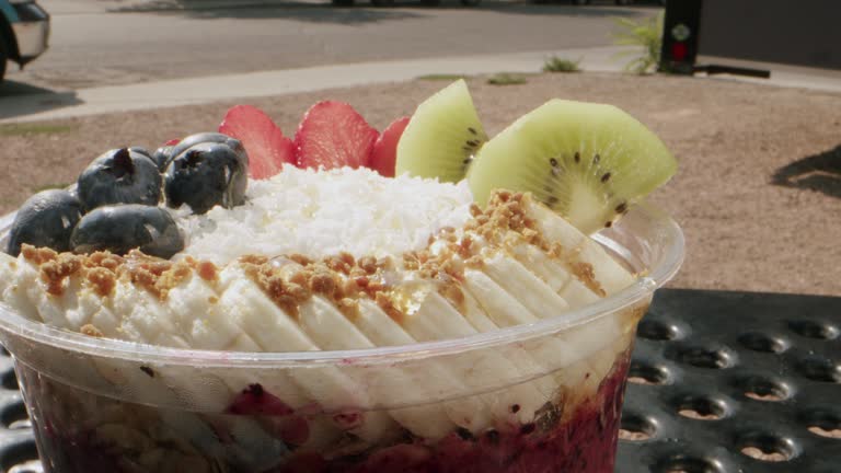 Extreme Macro Close-Up Shot of a Healthy Acai Food Bowl on a Picnic Table Outdoors in the Summer