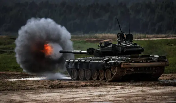 Photo of Shot from a tank gun with a smoke ring, the frame of military operations. Russian Modern tank Shooting at a target. Smoke, explosion, military Exercises, Military operations