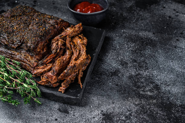 istock Texas Style BBQ Smoked Beef Brisket meat steak. Black background. Top view. Copy space 1352275662