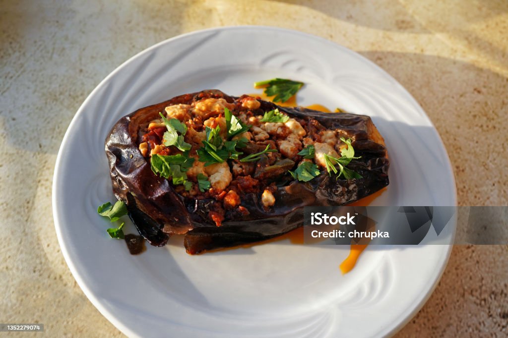 baked eggplant with feta cheese and herbs on the table in greek tavern baked eggplant with feta cheese and herbs on the table in greek tavern, typical greek cuisine Food Stock Photo