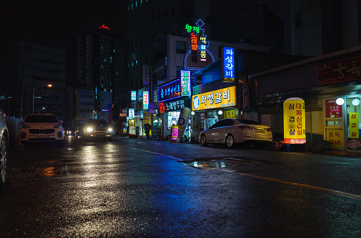 Busan, South Korea - March 19, 2018: Night street view with colorful advertising illumination, people walk the street in downtown
