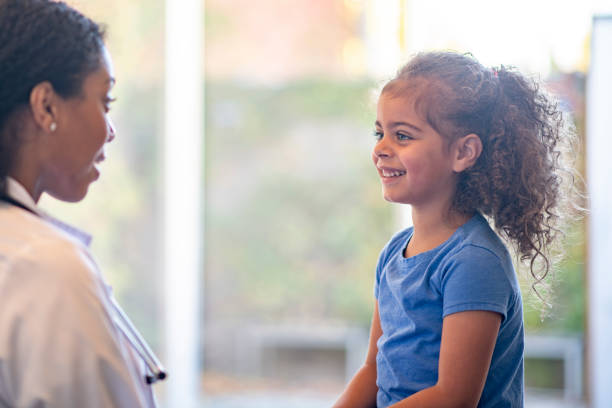 istock Little Girl Talking with the Doctor 1352283349
