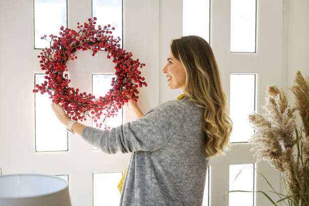 istock attractive middle aged woman  ( entrance hall, home decor) 1352283583