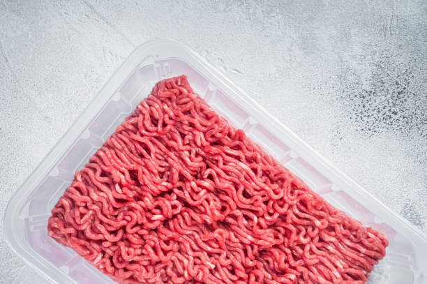 Fresh Raw mince beef and pork meat in vacuum packaging. White background. Top view
