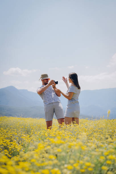 istock Boy paints his girlfriend in a sunny field 1352286338
