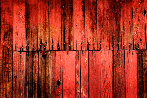 istock Old Red Barn Wooden Wall Background textured with several nails 1352287890