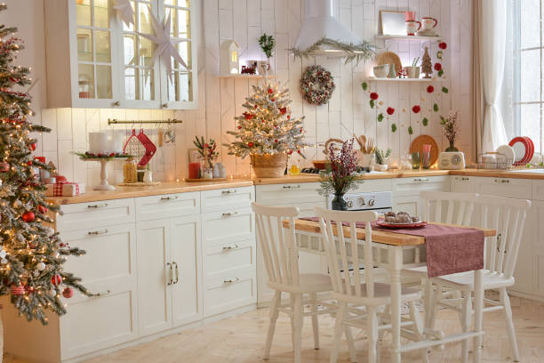 istock Interior of a light white ?hristmas kitchen with red decor elements in the Scandinavian style. Christmas decorations. Breakfast 1352289610