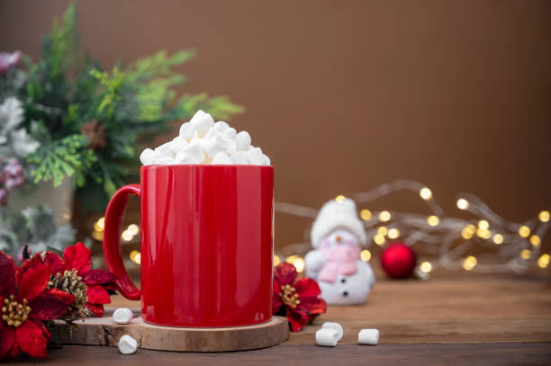 istock Red mug with hot chocolate, marshmallows. Christmas decoration on wooden background, copy space 1352292085