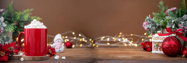 istock Red mug with hot chocolate and marshmallows with Christmas decoration on background, bokeh lights and copy space 1352292089