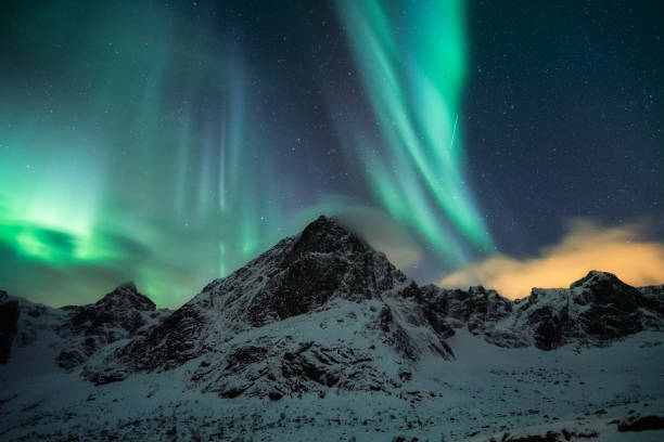 istock Aurora borealis, Northern lights with starry over snow mountain peak on winter 1352292169