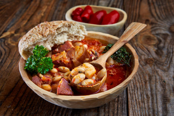 Smoked pork and beans stew on a rustic table stock photo