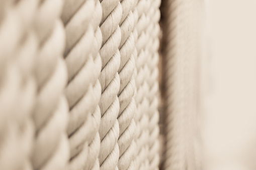 Strong white ropes weigh upright on white background