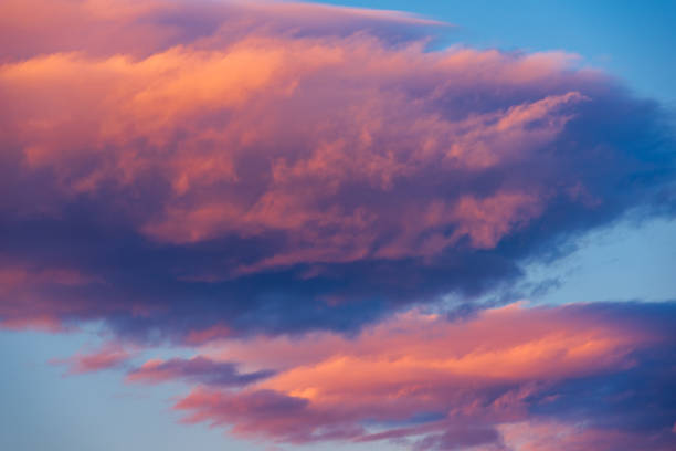 istock Vibrant Pink and Blue Clouds in Sky 1352292871