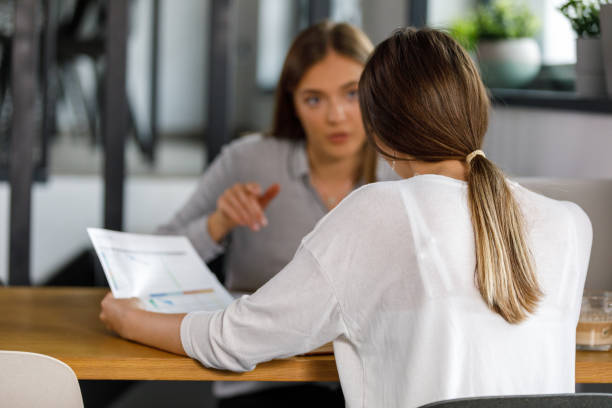 istock Two businesswomen sitting across from each other, discussing project ideas 1352292968