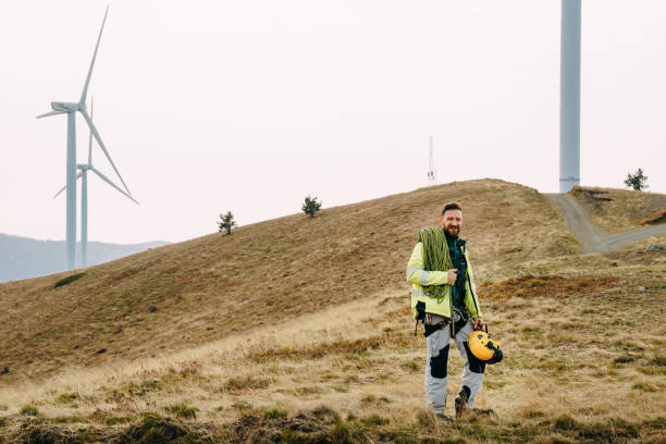istock Technician standing near wind turbines with climbing equipment 1352293190