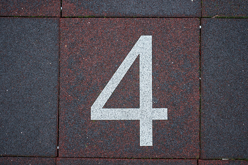 Number 4 in white on urban street tile