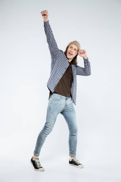 istock Vertical image of happy hipster posing in studio 1352296019