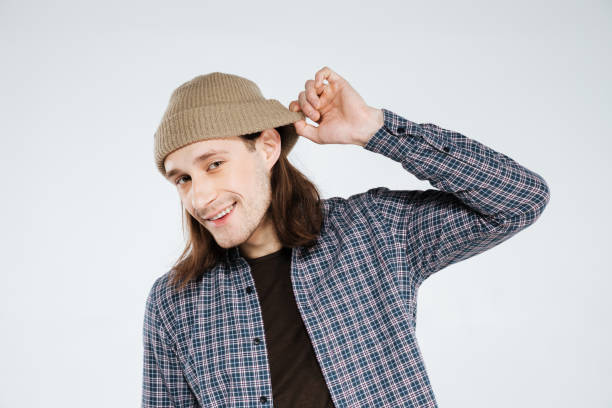 istock Smiling hipster holding hat and listening 1352296381
