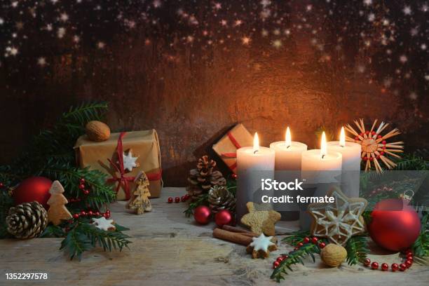 Fourth Advent Four Candles Are Lighted Christmas Decoration And Gifts On Rustic Wooden Planks Against A Dark Brown Background With Copy Space Selected Focus Stock Photo - Download Image Now