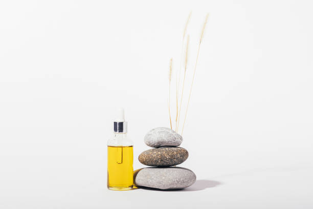 istock Organic cosmetic oil bottle next to stack of stones 1352299090