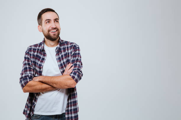 istock Laughing Bearded man in shirt with crossed arms 1352299131