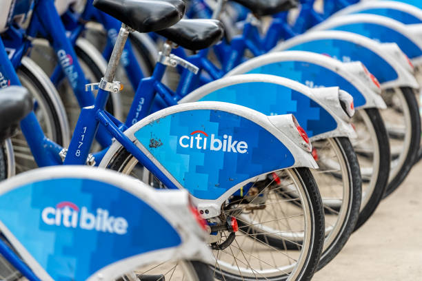 South Beach Lincoln road with closeup of many blue row parked Citi bank citibike bike rack rental bicycles Miami Beach, USA - January 17, 2021: South Beach Lincoln road with closeup of many blue row parked Citi bank citibike bike rack rental bicycles at parking docking station sidewalk street in city bicycle docking station stock pictures, royalty-free photos & images