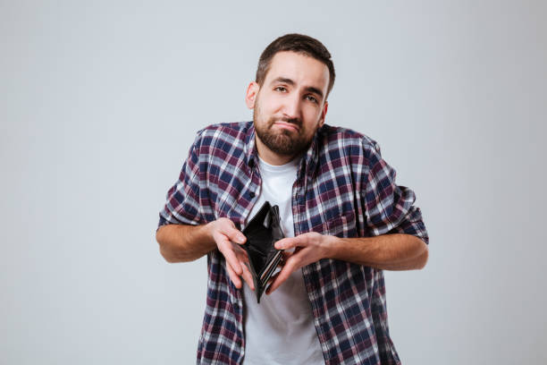 istock Bearded man in shirt with empty purse 1352299265