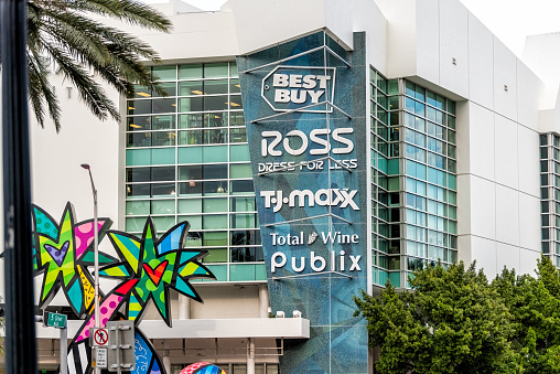 Miami Beach, USA - January 17, 2021: Florida South Beach modern downtown road shopping street with Ross, TJ Maxx, Best Buy and Publix sign on modern mall building