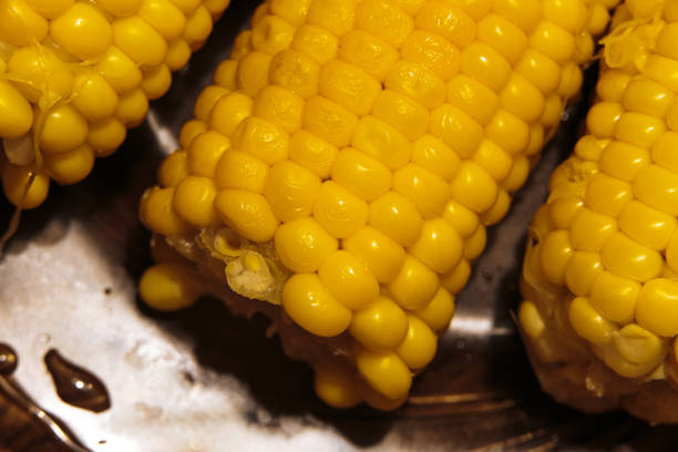 Freshly cooked corn close-up with shallow depth of field in dim light