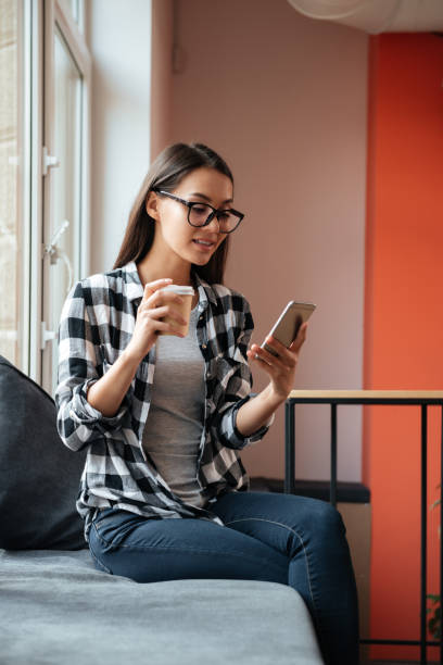 istock Caucasian lady chatting by phone and drinking coffee. 1352300652