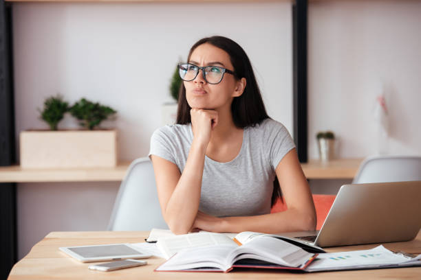 istock Concentrated woman indoors working with documents. 1352300945