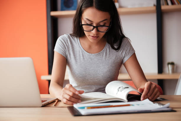 istock Amazing caucasian woman using laptop computer and reading 1352301393