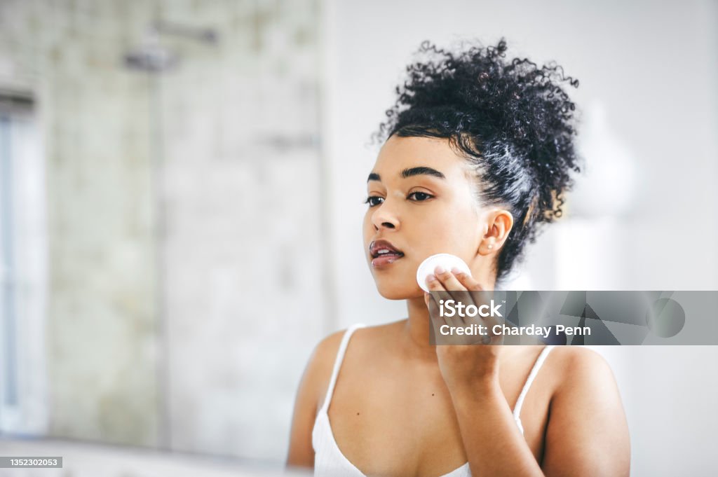 Shot of a beautiful young woman going through her morning routine at home Good looking skin starts with a good skincare regime Facial Cleanser Stock Photo