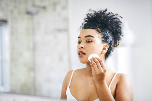 Shot of a beautiful young woman going through her morning routine at home Good looking skin starts with a good skincare regime facial cleanser stock pictures, royalty-free photos & images