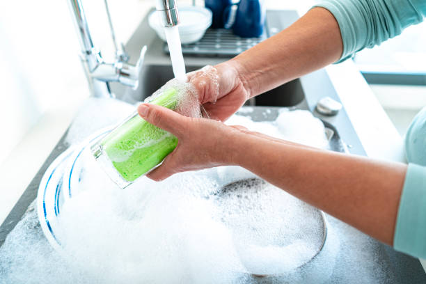 istock Washing drinking glass with a sponge 1352302482