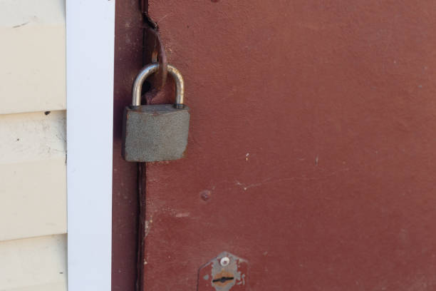 istock overhang lock hangs on the red iron door 1352303572