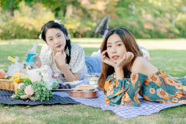 istock The two sisters are having a picnic outdoors. 1352305362