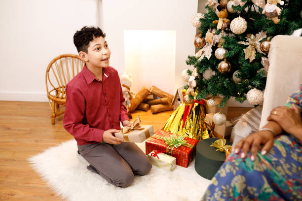 istock Happy boy receiving a Christmas gift 1352305640