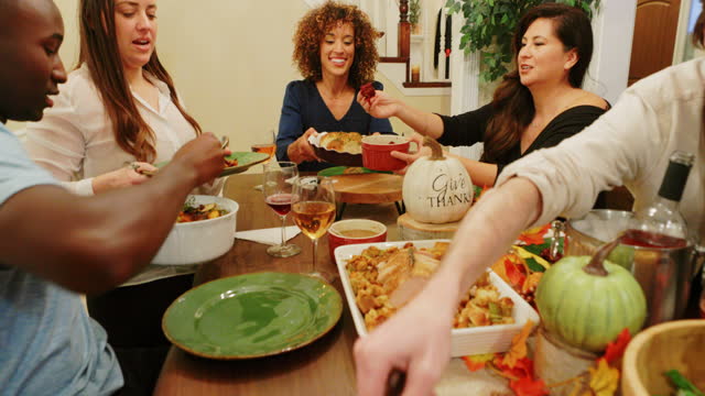 A group of friends celebrating Thanksgiving together with a Friensdsgiving.