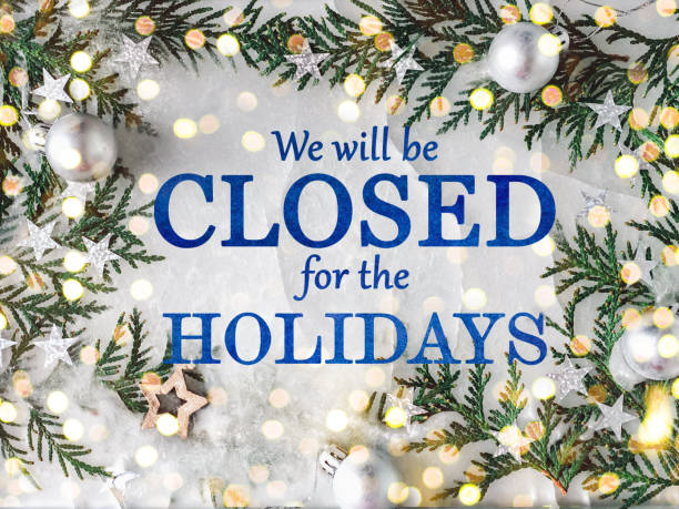 We'll be closed for the holidays. Signboard Signboard with the inscription We will be closed for the holidays and green branches of a Christmas tree. View from above, closeup, indoors, no people. Congratulations for family, friends, colleagues closed sign stock pictures, royalty-free photos & images