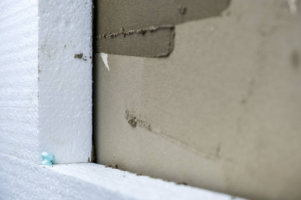 istock Installation of styrofoam insulation sheets on house facade wall for thermal protection. 1352309585