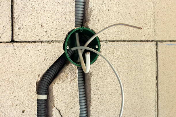 istock New electrical wiring installation, plastic boxe and electrical cable for future outlet sockets on the wall, renovation concept. 1352309756