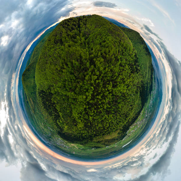 istock Little planet with dark mountain hills covered with green mixed pine and lush forest. 1352309829