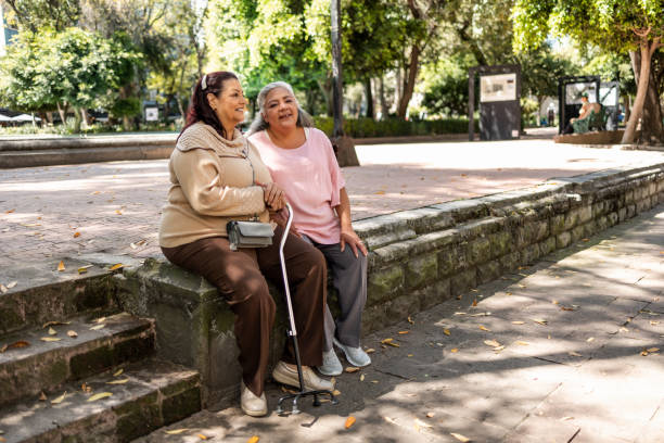 istock Two senior women sitting at the park 1352311908