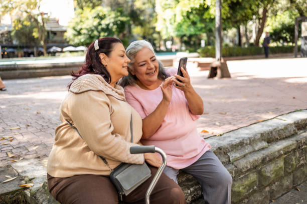 istock Two senior Hispanic women using mobile phone 1352312467