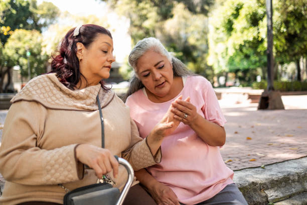 istock Two senior women sitting at the park 1352312835